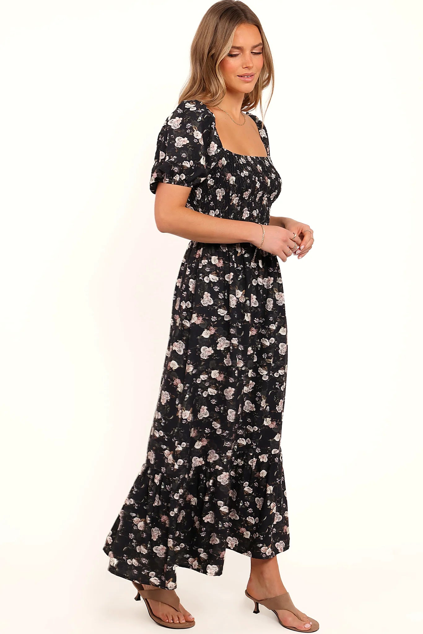 Ruffle hemline at the base of the black floral maxi