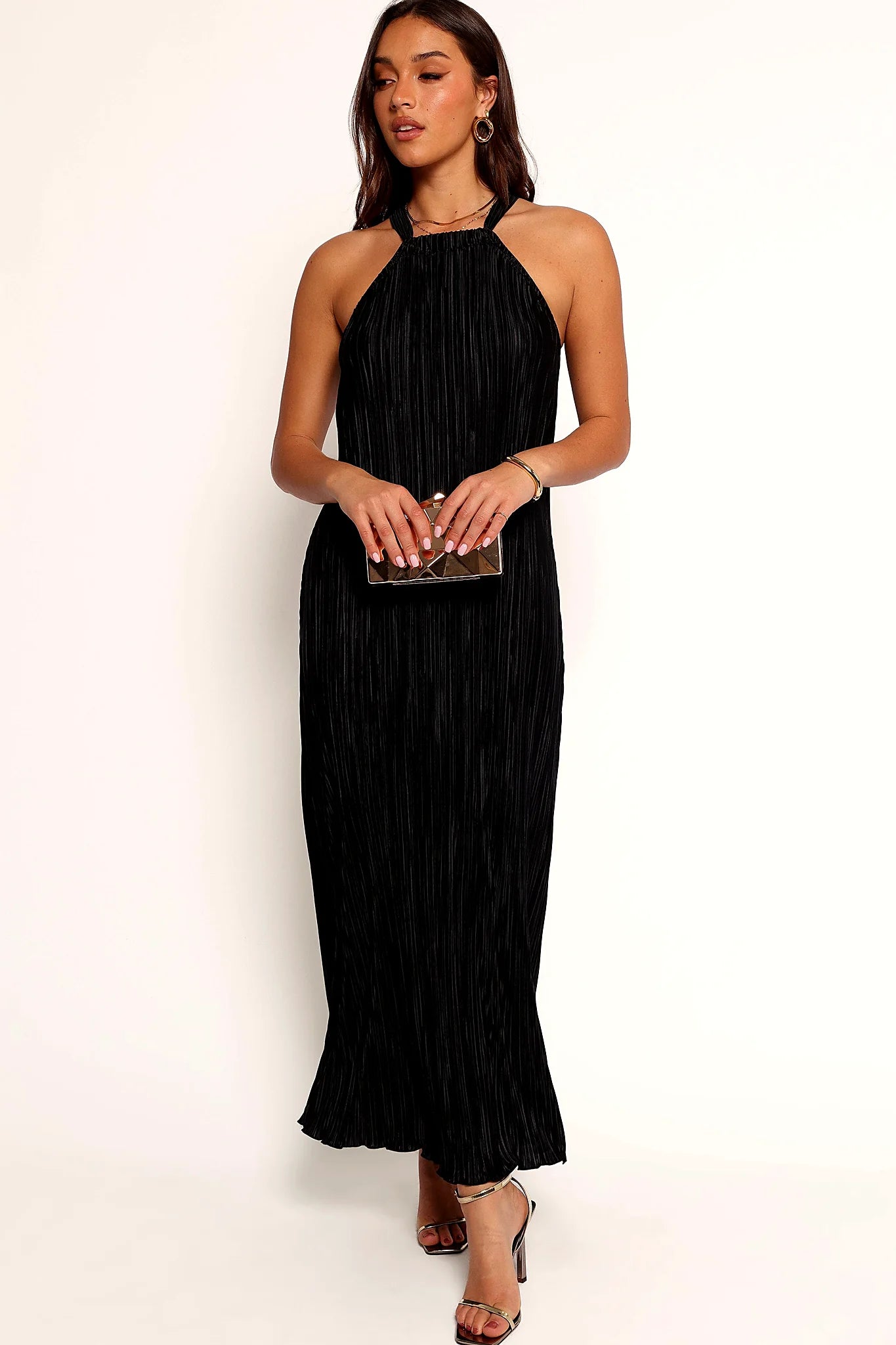 Halterneck and bare shoulders on the black plisse maxi