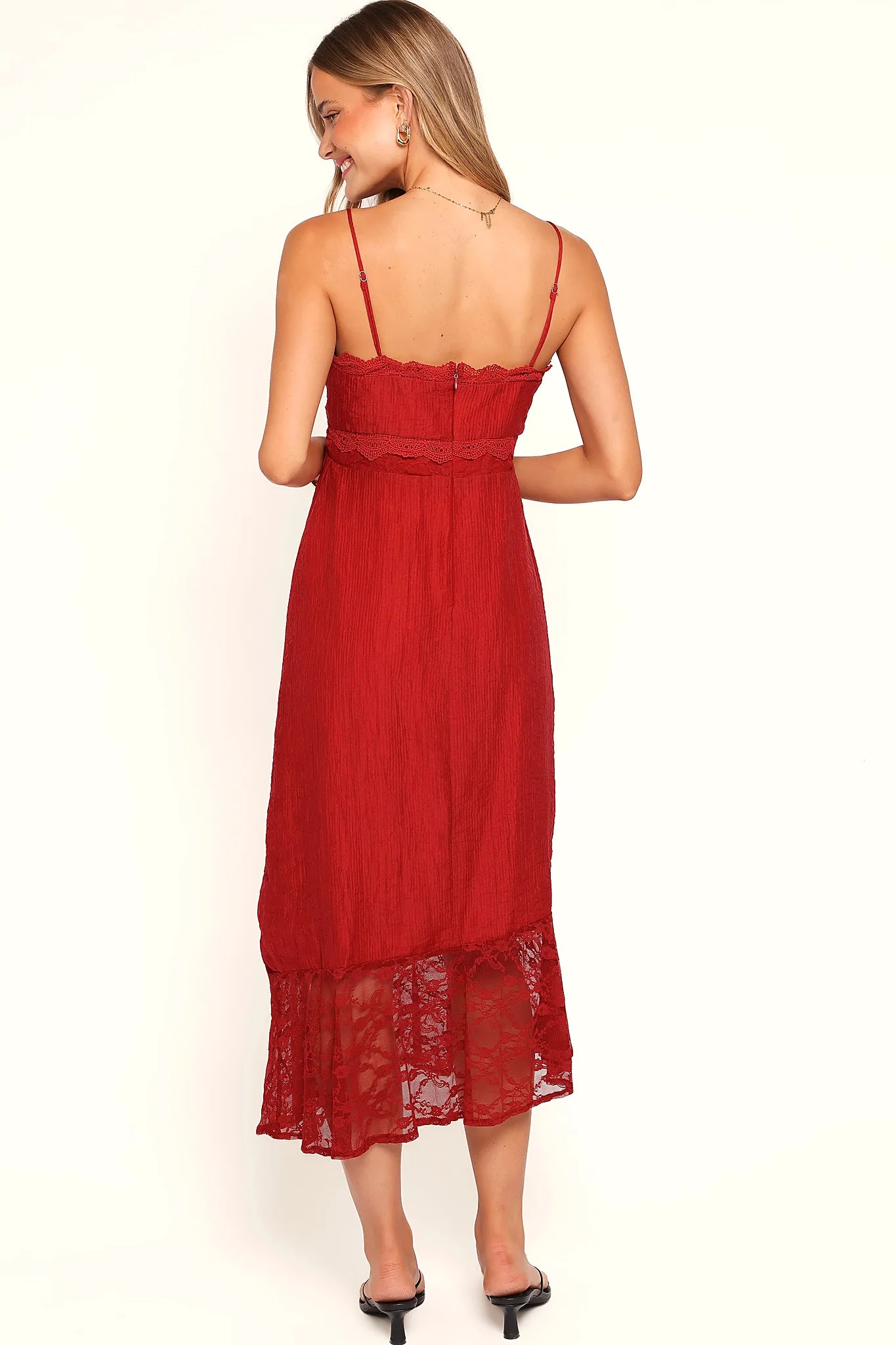 Lace trim detail against the red fabric